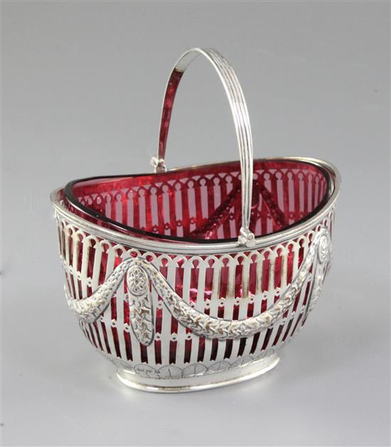 A Victorian silver swing handled sugar basket with cranberry glass liner, length 128mm, weight silver only 5.3oz/151grms